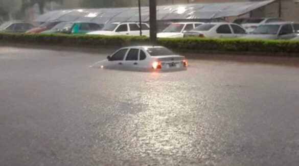 Auto en calle inundada.